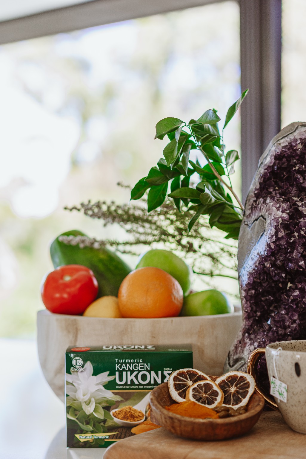 UKON turmeric supplement styled with fresh fruit and turmeric